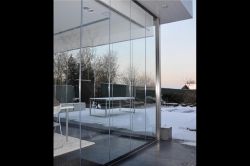 Frameless sliding enclosure in a private house